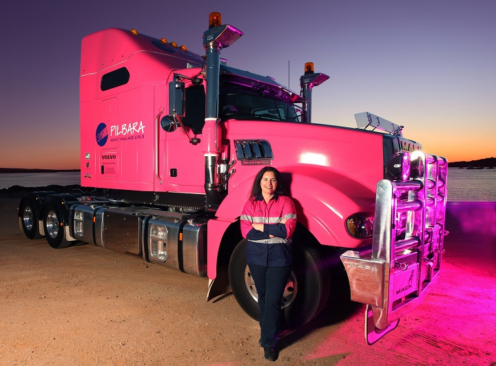 female truck driver heather jones in front of pink truck